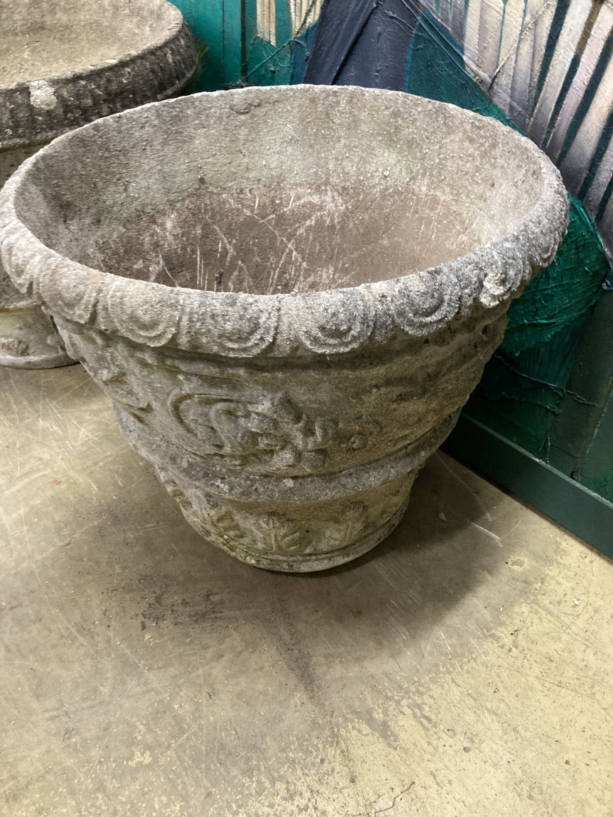 A circular reconstituted stone garden urn, 66cm diameter, height 50cm